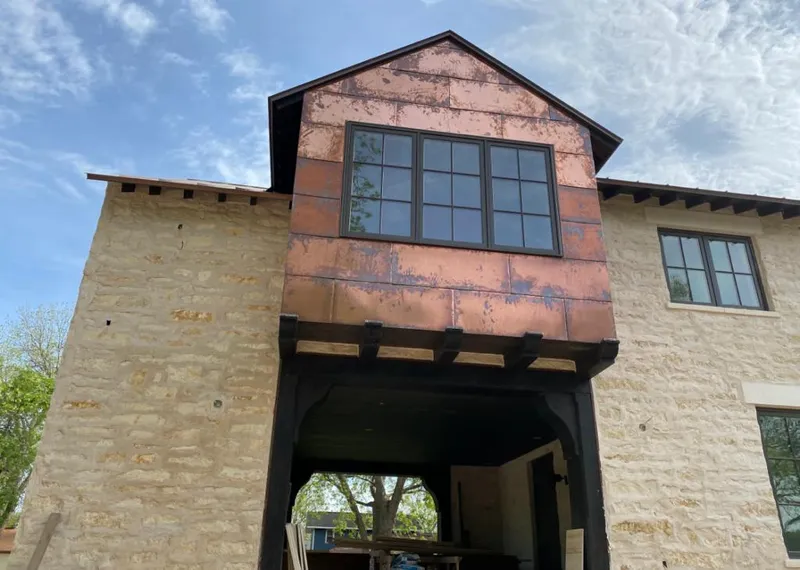 Copper metal panel facade on a stone building for Skylight Installation in San Gabriel